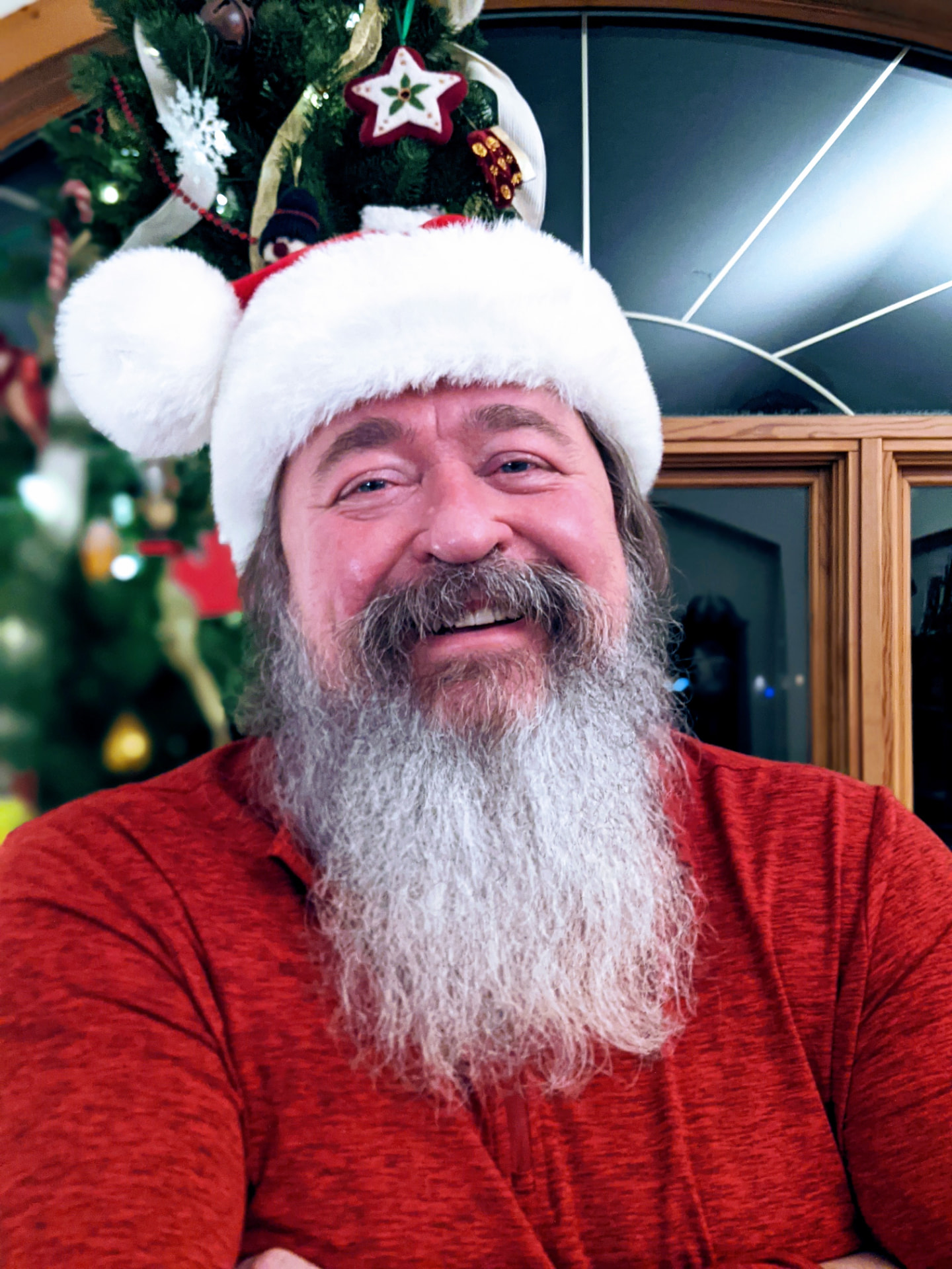 Leslie Piotrowski, creator of elfNsanta, wearing a Santa hat.